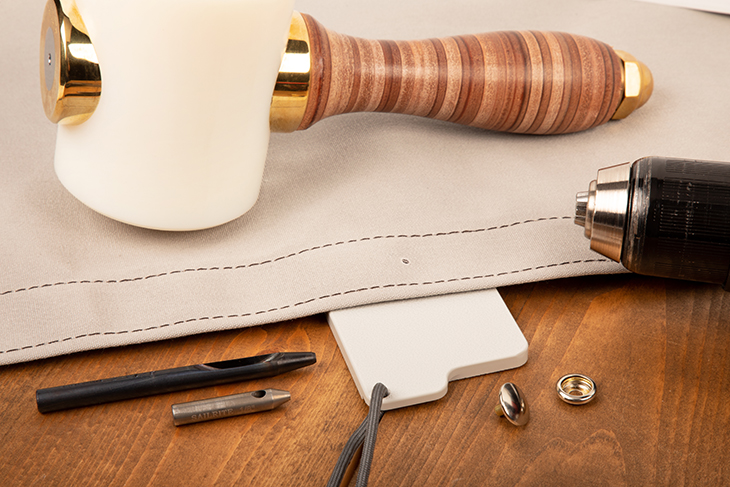 Cut holes in canvas for the twist-lock stud with a hole cutter or a Stayput Spin Cut.